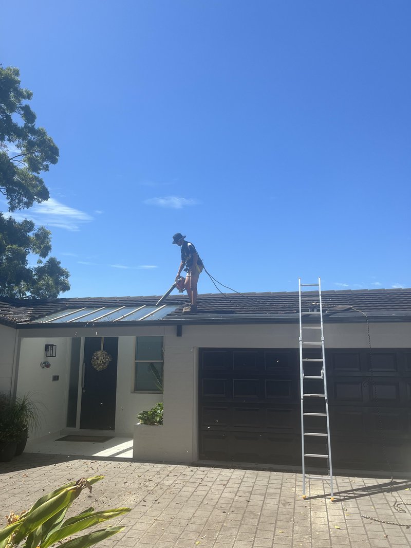 Adin from A&J Gutter Cleaning working on a roof